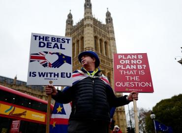 Anti-Brexit activist Steve Bray stands holding placards outside the Houses of Parliament in central London on Jan. 16. Photo: Tolga Akmen/AFP via Getty Images.