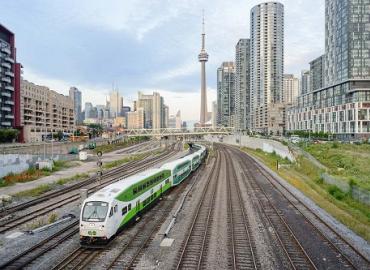 A GO train leaving Toronto with the CN tower in the background