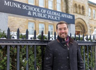 David Kepes standing outside of Munk School of Global Affairs &amp;amp; Public Policy.