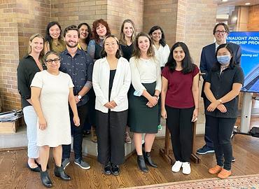 A group of students standing in a row with two professors