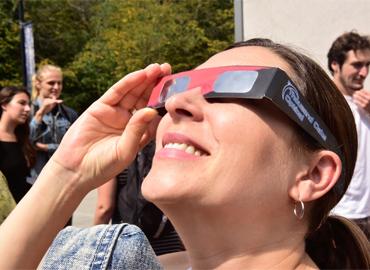 A person using glasses to look at an eclipse
