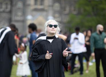 Elspeth Arbow wearing sunglasses and a Convocation gown