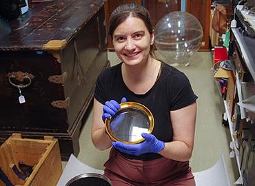 Victoria Fisher holding a lens.