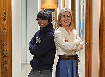Fateen Kabir standing back to back with Dean Melanie Woodin.