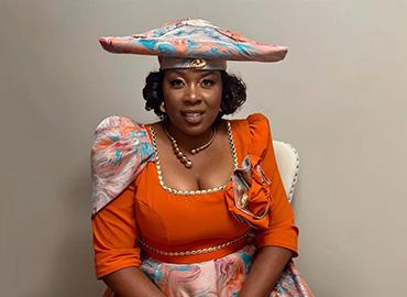Floria Kangootui, wearing traditional clothing from her homeland of Namibia