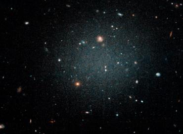 A Hubble Space Telescope image of the galaxy NGC1052-DF2. Distant galaxies are visible through DF2 due to its lack of stars and “ghostly” nature. 