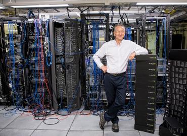 Geoffrey Hinton striking a relaxed pose in the server room of the machine learning group, in U of T’s Department of Computer Science