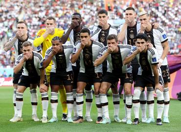 A photo of the German FIFA team with their hands covering their mouths