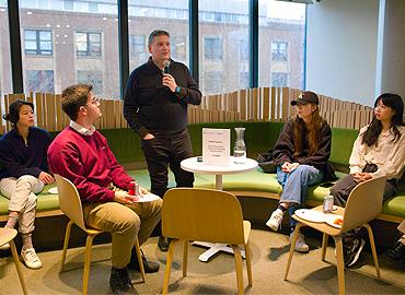 Giulio Fazzolari speaking to a group of people.