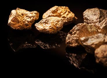 Chunks of gold against a black blackground