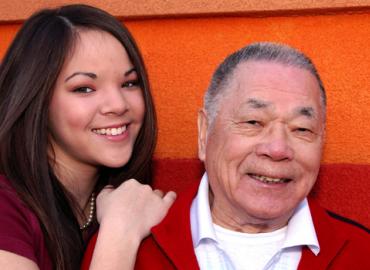 A young woman poses with her grandfather 