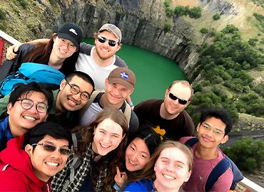 A group of students stand in front of the giant waterfilled Big Hole in Kimberley.