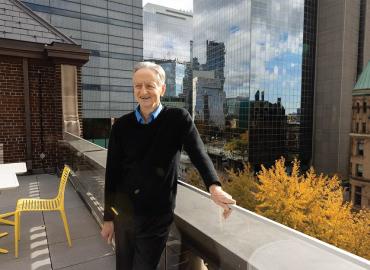 Geoffrey Hinton standing on a rooftop.