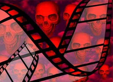Horror film Human skulls in the background Film reel Cinema stock photo
