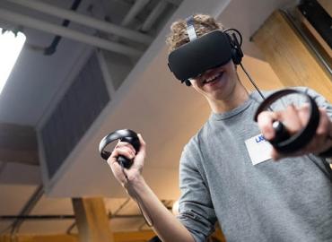 A computer science student tries a virtual-reality game on a class visit to the Uken Games studio in Toronto.