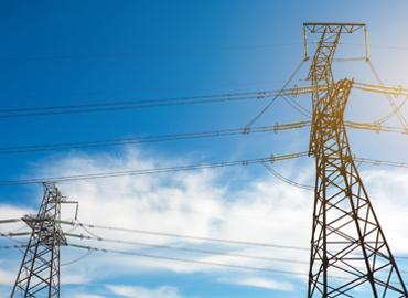 A bright blue sky with hydro lines.