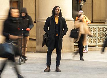 Ian Williams stands on a street.