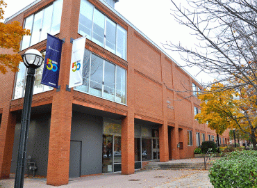 An outside view on Innis College on a cloudy day. 