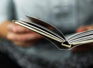 Close up on hands holding a book