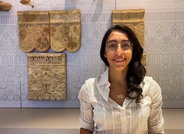 Claudia Paparella standing in front of a museum case