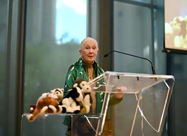 Jane Goodall speaking at a podium.