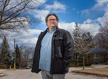 Jesse Wente standing on a street on a bright sunny day