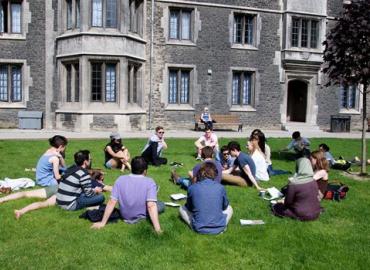 Students seated in a circle outside at U of T.