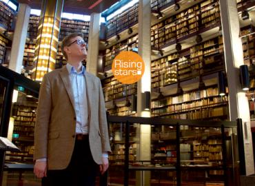 Joseph Clarke standing in the Thomas Fisher Rare Book Library.
