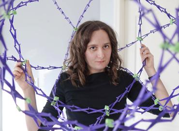 Kelly Lepo inside a bunch of purple wires.