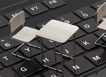 a miniature school desk on a keyboard