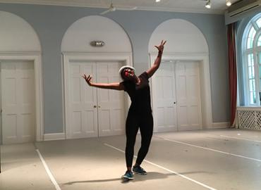 Lilian Adom doing a ballet pose wearing a clown nose