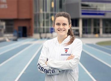 Lucia Stafford standing on a track