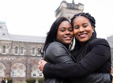 Lydia and Suzie, two students/alumni hugging at King&amp;#039;s College. 