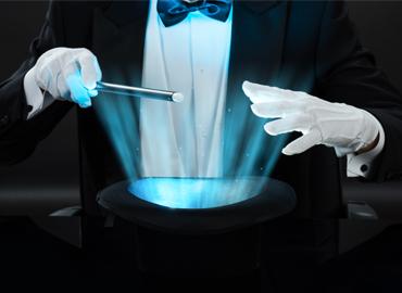 Two white gloved hands and a magician wand over a top hat.