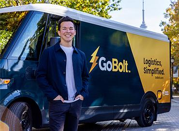 Mark Ang standing beside a yellow and black truck that says, &amp;quot;Go Bolt.&amp;quot;