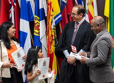 Mark Lautens laughs with some new Canadian citizens
