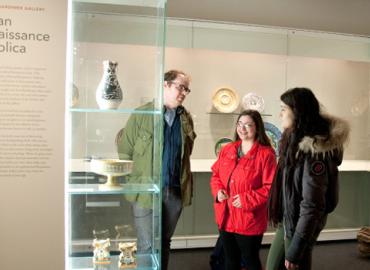 Trevor Dunseith, Kaite Paolozza and Kristen Manza looking at artifacts