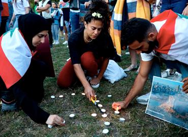 Mourners light candles in London&amp;#039;s Kensington Gardens during a vigil to honour the victims of the Beirut explosion