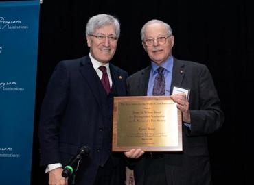 Professor David Novak poses next to Princeton professor Robert George while holding his award plaque.