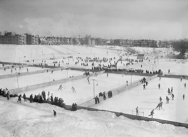 A black and white photo of an outdoor staking rink.