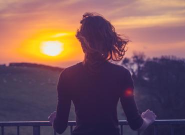 A person looking at a sunset.