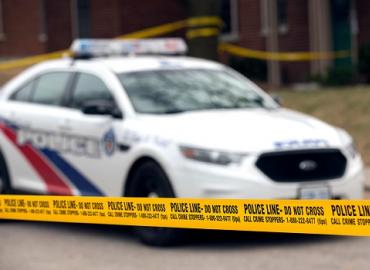 A Toronto Police car behind caution tape