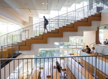 A person walking down the stairs in a building.