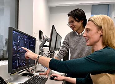 Bryan Hong and Professor Morgan Barense looking at a computer.