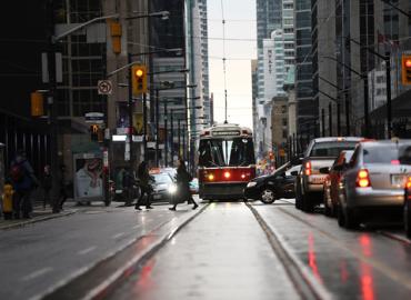 A busy Toronto street, including pedestrians, cars and a streetcar
