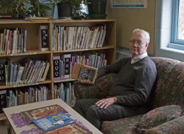 U of T professor Robert Vipond sits in the library of the Clinton Street Public School. 