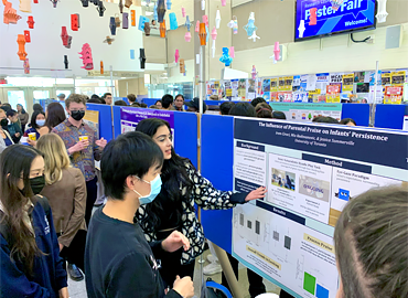 Students presenting research posters at the poster fair