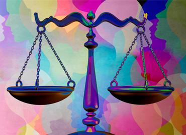 scales of justice in front of an image of multi-colored silhouette