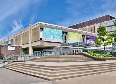 An outside view of Sidney Smith Building on a sunny day.