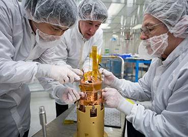 Three men performing final adjustments to SNOLAB Engineering Tower